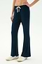 A person wears SPLITS59's Blaire Rib Pant in Indigo, made from soft modal fabric, with white sneakers—pictured waist down against a plain light backdrop.