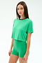A woman stands against a white background wearing the SPLITS59 Djuna Crop Ringer in Spearmint/Indigo, a green cropped t-shirt made from soft viscose fabric.