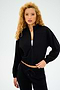 A person with curly hair poses against a plain background, exuding style in the all-season Harlowe Rigor Jacket - Black by SPLITS59, paired with matching pants.