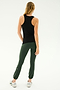 A person with long hair is facing away, wearing the SPLITS59 Kiki Rib Tank Full Length in black, green leggings, and white sneakers, poised as if ready for yoga or gym workouts against a plain light background.