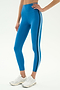 A person wears SPLITS59 Ella High Waist Airweight 7/8 leggings in Stone Blue/Graphite, featuring black and white side stripes—ideal for hot yoga—paired with white athletic shoes, against a plain background.