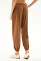 Model wears SPLITS59 Andie Oversized Fleece Sweatpant - Toffee with white sneakers, shown from the back against a plain white background.