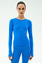A person wears the SPLITS59 Airweight Lite Long Sleeve Waist Length top in Classic Blue, paired with matching blue leggings, standing against a plain white background.