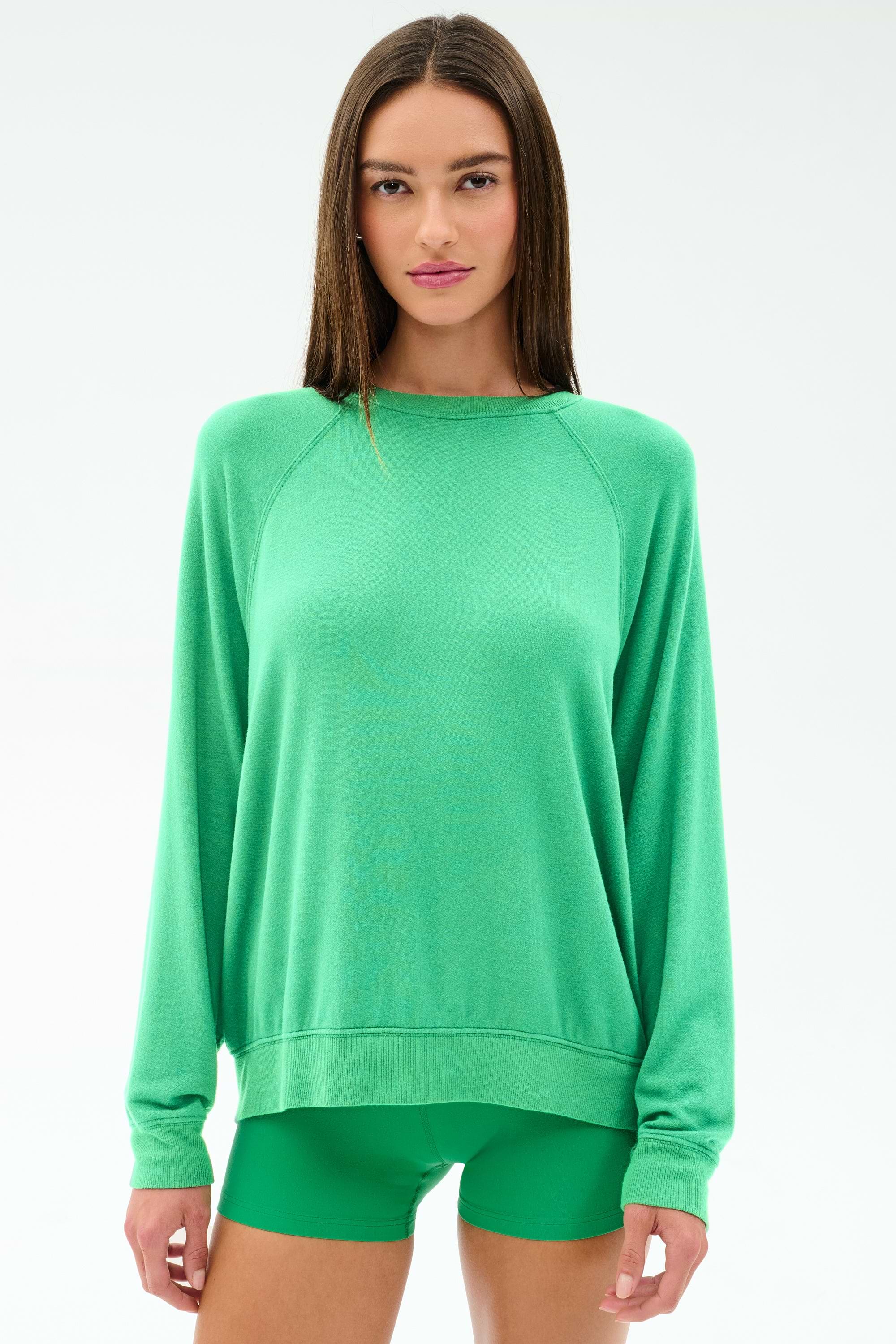 A woman wears the SPLITS59 Andie Oversized Fleece Sweatshirt in Spearmint, standing facing forward against a plain white background.