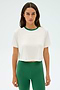 Confidently standing against a plain background, the person sports the stylish SPLITS59 Djuna Crop Ringer in White/Arugula, crafted from a comfortable elastane blend.
