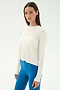 A woman stands against a plain backdrop wearing the SPLITS59 Djuna Long Sleeve in White and bright blue leggings, looking at the camera with a neutral expression—ready for gym or outdoor workouts.