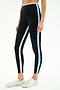 A person models the SPLITS59 Sam High Waist Rigor 7/8 leggings in Black/Skylight, featuring vertical white and blue stripes, paired with white and silver athletic shoes against a plain background.