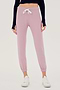 Front view of woman wearing light pink sweatpant jogger with white drawstring and black turtleneck cropped long sleeve paired with white shoes