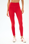 A person wears SPLITS59 Airweight High Waist Legging in Pirate Red and white sneakers with red accents, standing against a light backdrop—ideal attire for hot yoga sessions.