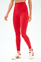 Someone wearing SPLITS59’s Airweight High Waist Legging in Pirate Red and white Adidas sneakers with red stripes stands against a plain white background.