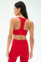A woman, seen from the back against a light background, wears the SPLITS59 Sara Airweight Bra in Pirate Red with matching leggings—ideal activewear for Pilates or hot yoga.