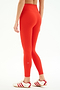 Model wears the SPLITS59 Airweight Rib High Waist 7/8 leggings in Lotus Red, styled with white sneakers with red stripes. Shown from the back against a plain white background—ideal for Pilates or hot yoga, offering comfort and style.