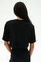 Person with long braided hair wears the SPLITS59 Djuna Oversized Crop Jersey Tee in black, a loose short-sleeve crop top shown from the back against a plain background.