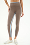 Someone wearing the SPLITS59 Sam High Waist Rigor 7/8 leggings in Lentil/White with blue and white side stripes, styled with silver sneakers, stands against a plain background.