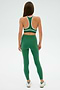 Individual wearing a SPLITS59 Layla Airweight Bra in Arugula/Indigo, seen from behind against a plain backdrop.