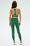 Individual wearing a SPLITS59 Layla Airweight Bra in Arugula/Indigo, seen from behind against a plain backdrop.