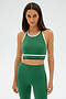 A person wearing a SPLITS59 Layla Airweight Bra in Arugula/Indigo and matching leggings stands against a plain background.