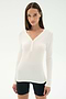 A woman wears the SPLITS59 Louise Rib Henley in white and black spandex shorts, standing against a plain white background.