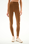 Model wearing SPLITS59 Airweight High Waist - Toffee leggings with light athletic shoes, ideal for hot yoga, posing against a plain white background.