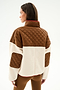 Woman facing away in the SPLITS59 Skylar Sherpa Jacket - Creme/Toffee, a 100% polyester quilted piece with high collar, paired with matching brown pants.