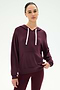 A woman wearing the SPLITS59 Joey Fleece Hoodie in Dark Cherry, featuring white drawstrings and paired with matching leggings, crafted from a soft modal fabric blend, stands against a plain white background.