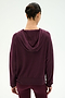 A person with dark hair in a bun is shown from the back against a plain white background, wearing the SPLITS59 Joey Fleece Hoodie in Dark Cherry paired with matching leggings.