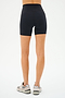 Viewed from the back, a person wears SPLITS59's Airweight High Waist Short in black and gray sneakers, ready for cycling against a plain white backdrop.