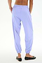 Person wearing SPLITS59 Megan Woven Nylon Jogger in Purple Haze and black ballet flats, shown from the back against a plain white background.