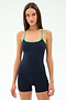 A woman faces forward, wearing the SPLITS59 Airweight Tank in Indigo/Spearmint with matching shorts made from stretchy fabric, set against a plain light background.