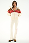 Woman stands facing forward in the SPLITS59 Aspen Puffer Jacket - Creme/Terracotta with flared pants featuring a side stripe and brown shoes.