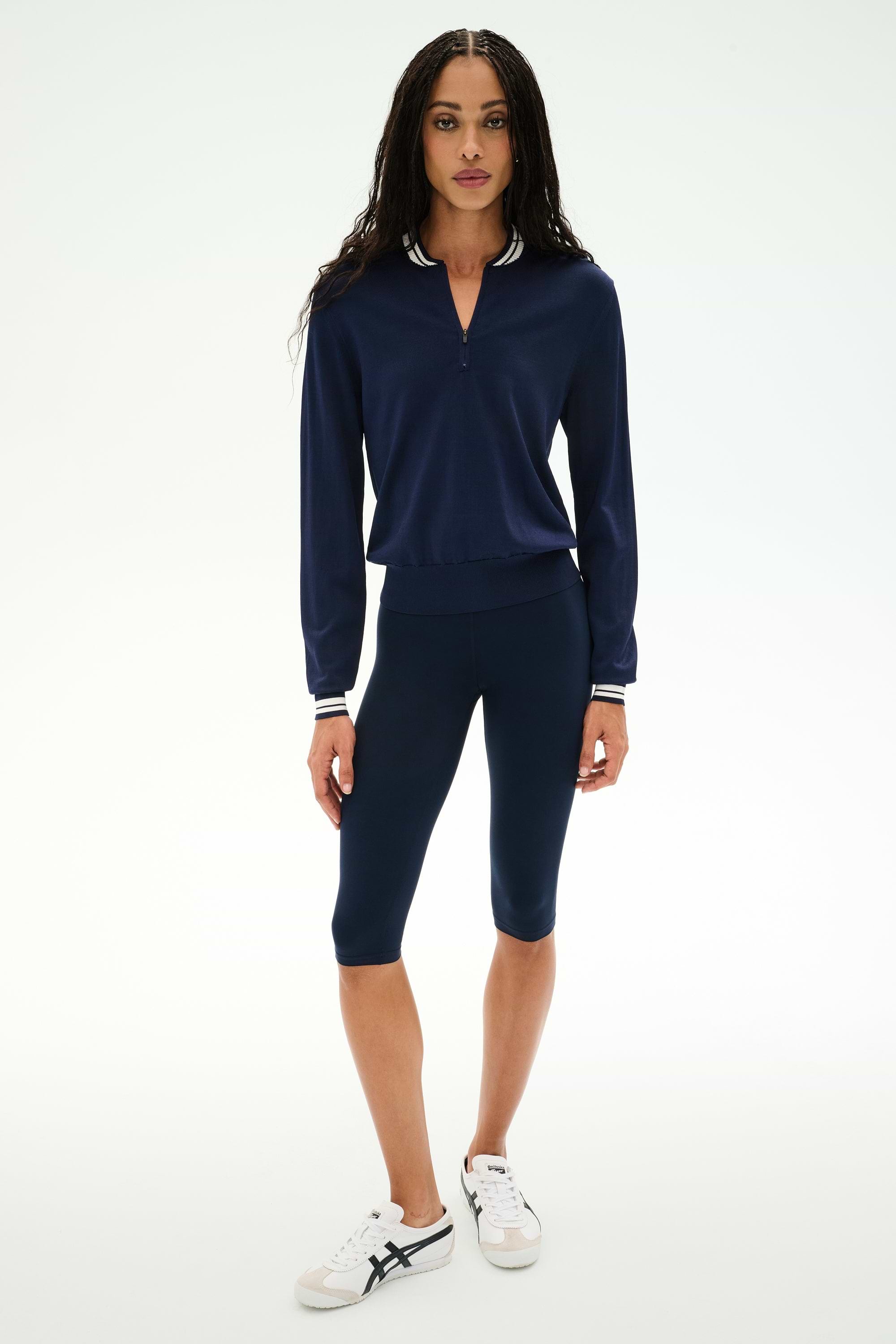 A person wearing the SPLITS59 Bonnie Knit Half Zip in Indigo/White stands against a plain white background.