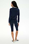 A person stands facing away, wearing the SPLITS59 Bonnie Knit Half Zip in Indigo/White, paired with matching navy knee-length leggings and white sneakers with black accents, against a plain white background.