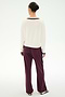 A person stands with their back to the camera, wearing a white long-sleeve spandex top, SPLITS59 Maxie Rigor Track Pants in Dark Cherry/Black, and flat shoes. Their hair is styled in a neat bun against a plain white background.