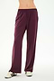 A person wearing the SPLITS59 Maxie Rigor Track Pant in Dark Cherry/Black, crafted from a soft nylon-spandex blend, paired with white sneakers featuring black stripes, stands against a plain white background.