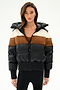 A woman wears the SPLITS59 Aspen Puffer Jacket - Black/Toffee with black leggings, set against a plain white background.