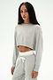 Model wears the SPLITS59 Noah Fleece Crop Sweatshirt in Heather Grey, paired with matching sweatpants featuring white drawstrings, all crafted from soft modal spandex, posed against a plain white background.
