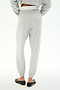A person wears SPLITS59's Andie Dual Waist Sweatpant in Heather Grey/White with an elastic waist and cuffs, paired with black flats and a cropped gray long-sleeve top, standing on a white background.