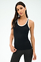A woman stands against a plain background wearing the SPLITS59 Ashby Rib Tank in Black/White, paired with dark leggings—an ideal outfit for gym sessions.