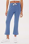 Woman standing in SPLITS59 Brooks Fleece Cropped Flare - Steel Blue sweatpants and white sneakers, cropped view showing only from waist to shoes.