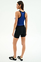 A woman faces away, wearing the SPLITS59 Kiki Rib Crop Tank in Cobalt/Black with black shorts and black athletic shoes against a plain white background.