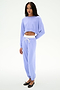 A person wears the SPLITS59 Andie Dual Waist Sweatpant in Purple Haze/White, featuring a stretchy fit, paired with a lavender cropped sweatshirt, standing against a plain white background.