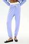 Person wearing SPLITS59 Andie Dual Waist Sweatpant in Purple Haze/White, featuring a white drawstring and stretchy fabric, paired with black ballet flats, shown from waist to feet against a plain background.