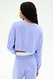 A person with long braided hair is shown from the back wearing the SPLITS59 Noah Fleece Crop Sweatshirt in Purple Haze, paired with matching stretchy pants, set against a plain light background.