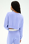 A person with long braided hair is shown from the back wearing the SPLITS59 Noah Fleece Crop Sweatshirt in Purple Haze, paired with matching stretchy pants, set against a plain light background.