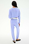 A person faces away from the camera, wearing the SPLITS59 Noah Fleece Crop Sweatshirt in Purple Haze with matching pants and black flats.