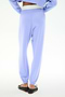 Model showcases the SPLITS59 Andie Dual Waist Sweatpant in Purple Haze/White from the back, featuring a stretchy fit and dual-tone waistband, styled with black slip-on shoes against a white background.