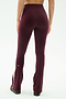 A person is seen from the back against a plain background, wearing SPLITS59's Raquel High Waist Flared Legging in Dark Cherry/Creme, crafted from a nylon-spandex blend and featuring a white side stripe.