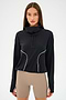 A person wearing the SPLITS59 Rosie Airweight Jacket in black and beige shorts stands against a plain background.