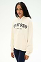 A woman with long braids wears the SPLITS59 Stella French Terry Oversized Hoodie in Creme/Splits59 Los Angeles—a soft 100% cotton sweatshirt featuring signature "SPLITS59 LOS ANGELES" text—paired with dark leggings, standing against a plain white background.