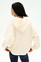 A woman stands with her back to the camera, hands on her hips, wearing the SPLITS59 Stella French Terry Oversized Hoodie in Creme, paired with navy leggings, set against a plain white background.